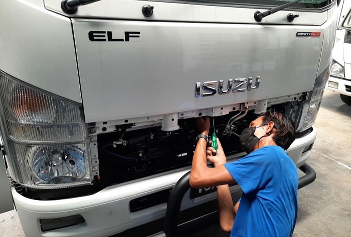 A Katsana exec installing fleet monitoring equipment on a truck.