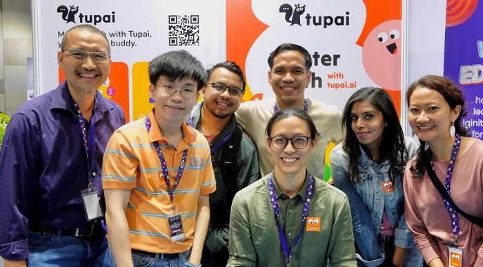  Founders, Andre Sequerah (left) and Edmond Yap (seated) with members of the Tupai team at the MyDigitalMakerFair 2024.