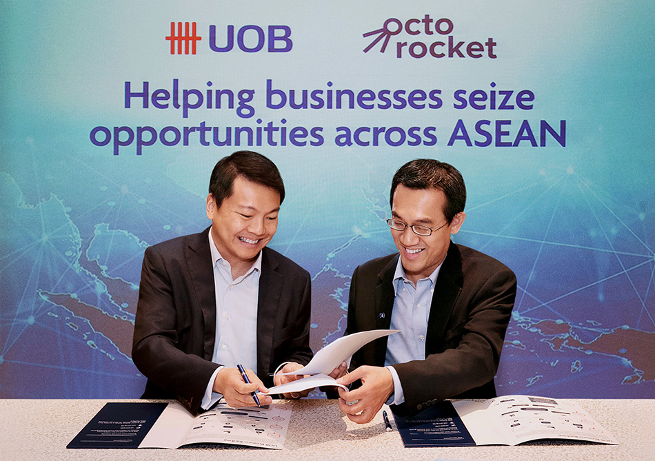 UOB Group Business Banking head Lawrence Loh (left), with OctoRocket chairman and SPH Digital Business chief Julian Tan